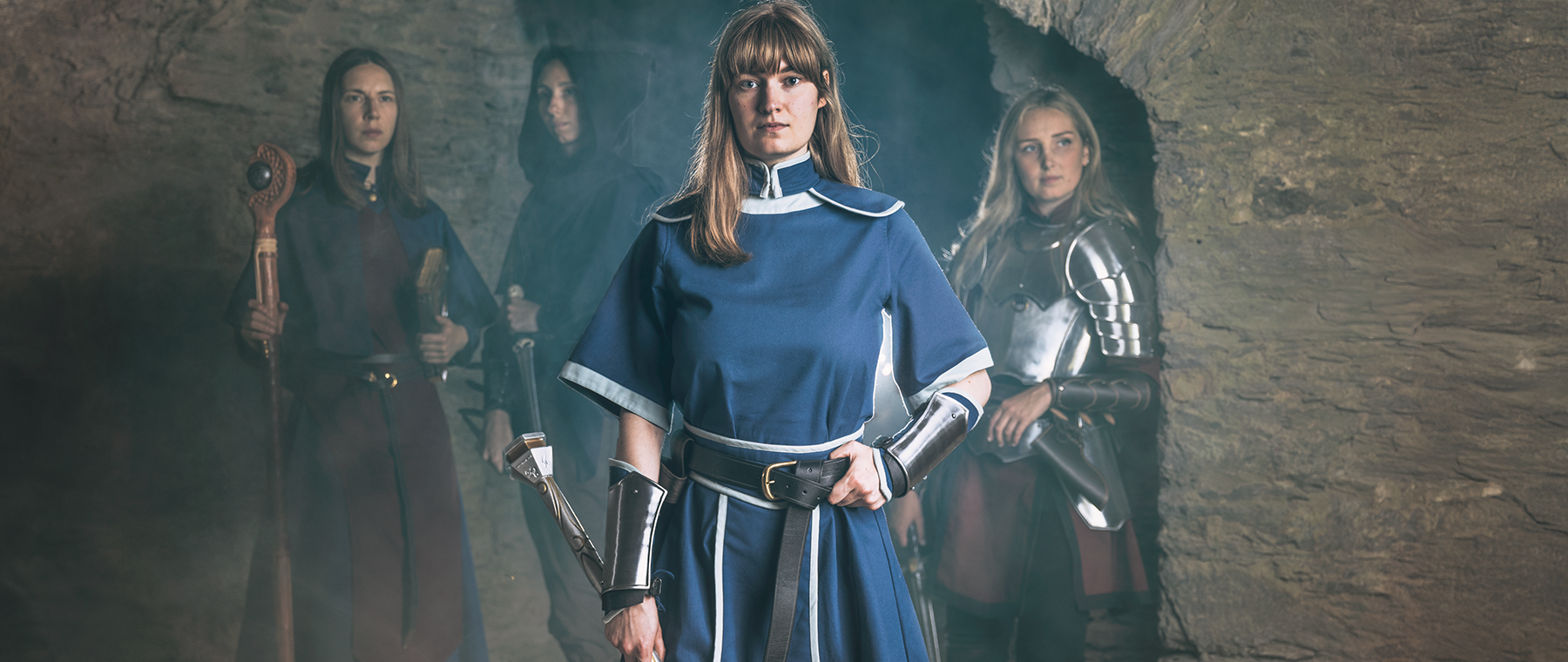 Cleric in a dark blue garb and a large mace. Official Dungeon & Dragon cleric costumes.