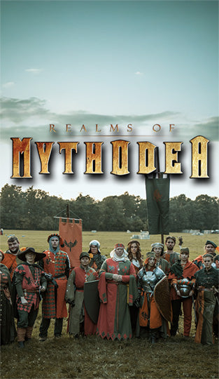 Group of people in medieval attire standing in a field with 'Realms of Mythodea' text above.