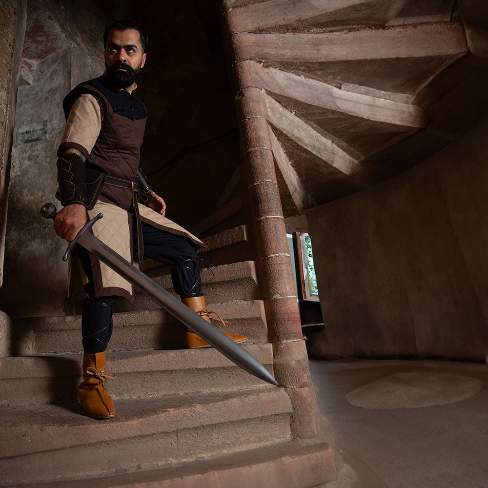 D&D fighter, dressed in garments from Brugschneider, is guarding the stairs.