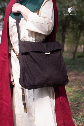 The vesker bag in brown worn on a shoulder